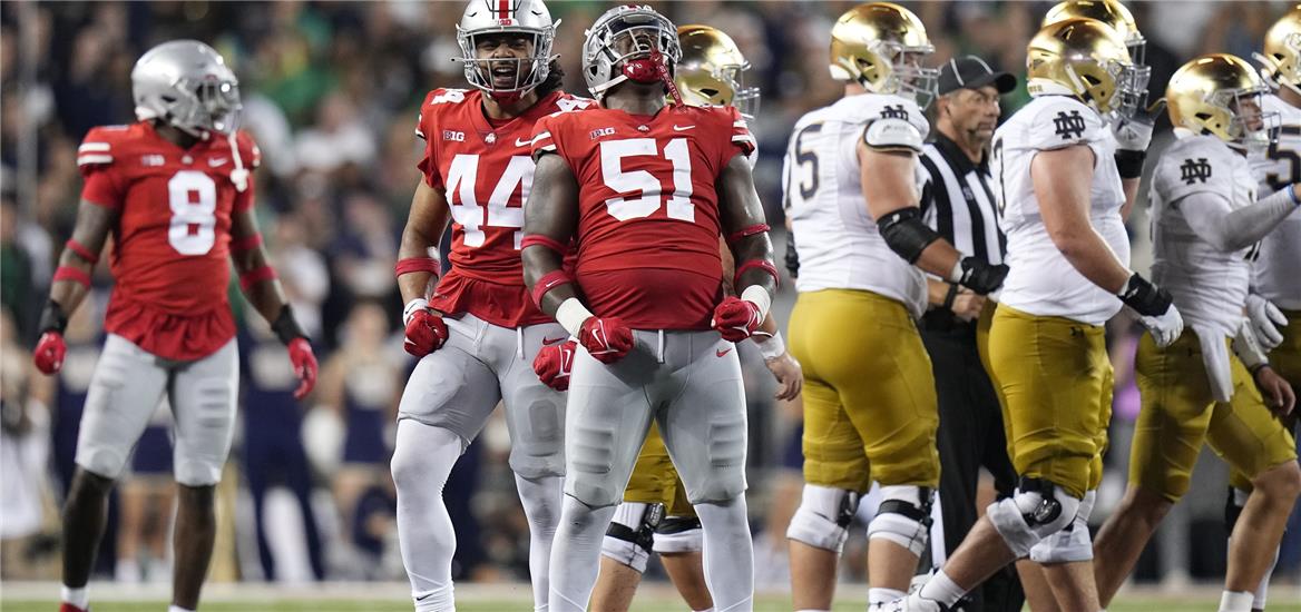 Ohio State Buckeyes defensive tackle Michael Hall Jr. (51) celebrates with defensive end J.T. Tuimoloau (44) after a tackle against the Notre Dame Fighting Irish during the fourth quarter at Ohio Stadium. Ohio State won 21-10. Adam Cairns-USA TODAY Sports

                    
