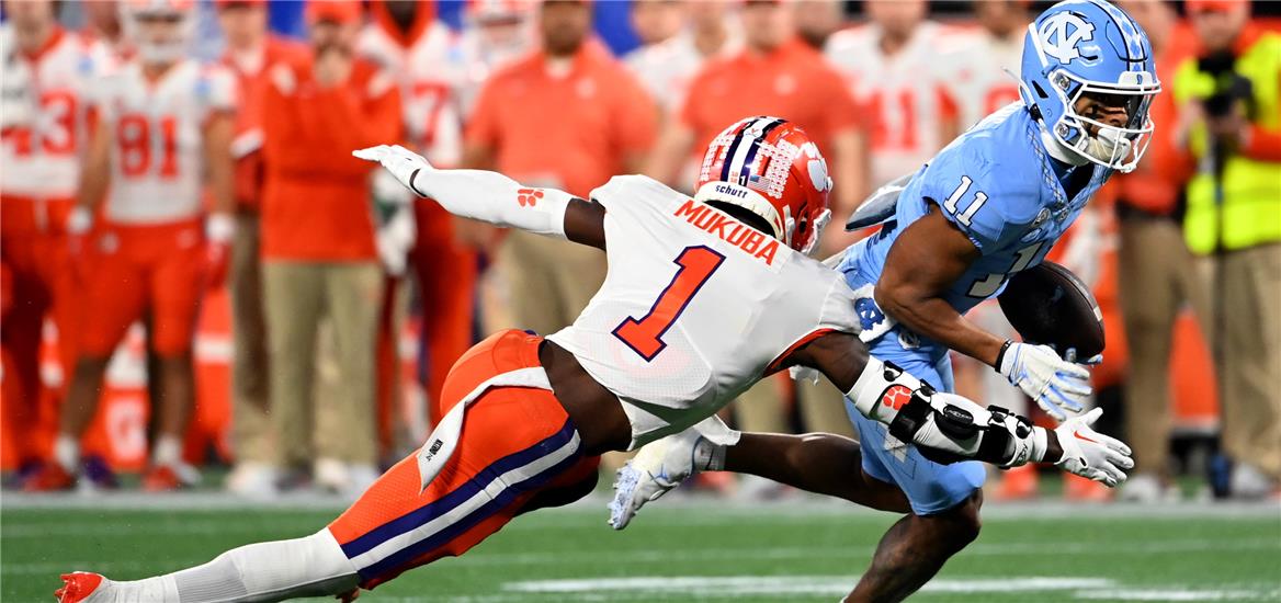 North Carolina Tar Heels wide receiver Josh Downs (11) is tackled by Clemson Tigers safety Andrew Mukuba (1) during the second quarter of the ACC Championship game at Bank of America Stadium.  Bob Donnan-USA TODAY Sports

                    